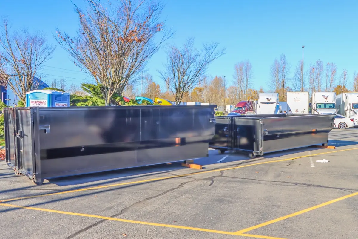 Professional dumpster rental service with roll-off container on residential driveway in Bonne Terre